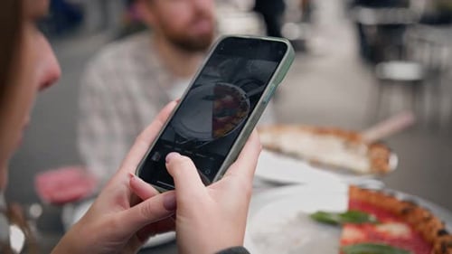 Photographing pizza in a restaurant