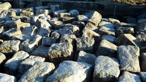 Panning shot of a rocky ground pattern, at sunset