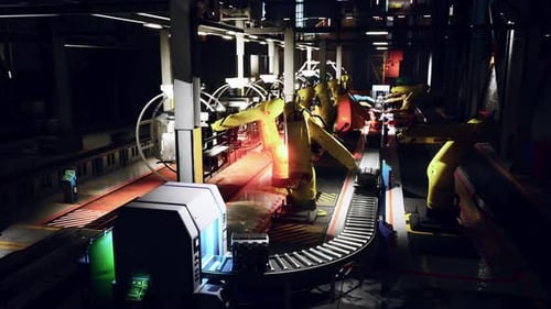 Funcionamiento nocturno de una cinta transportadora automatizada con brazos robóticos