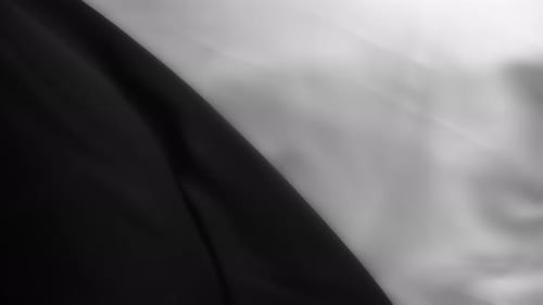 Silky black and white fabrics waving in the wind. Abstract texture background.