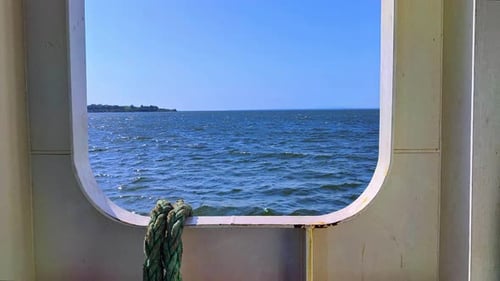 Ocean Waters From A Moving Ship Deck And The Island Across