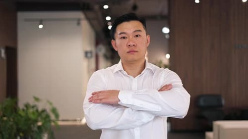 Proud Businessman with Confident Look Gazing at Camera in Office Place