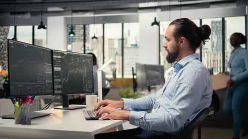 Man Typing at Computer in Modern Office