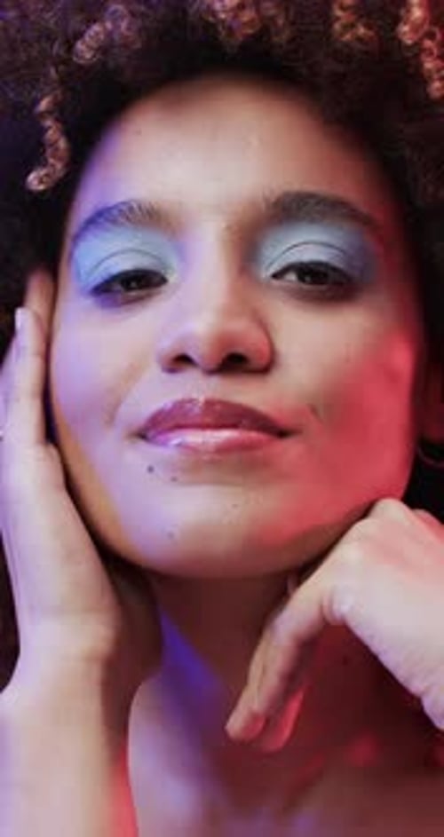 Close Up of Woman with Makeup in Colored Lighting
