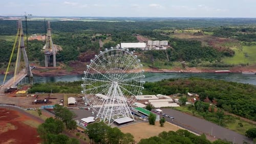 Ferris Wheel Near Incomplete Bridge Over River