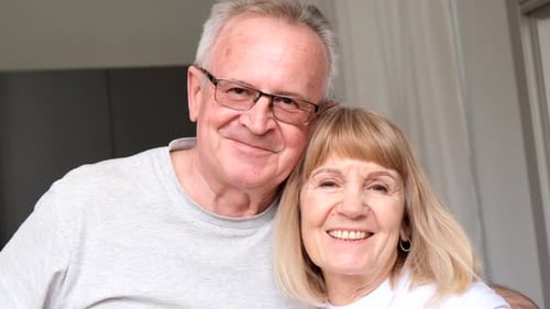 Happy Senior Couple Smiling in Home Interior