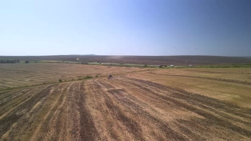 Tractor working on the field doing tillage with cultivator