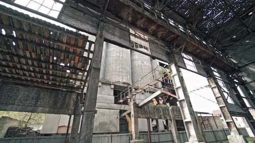 Ruins of an old factory. Interior of an abandoned derelict industrial structure.
