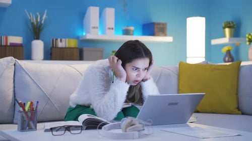 Woman Working on Laptop with Frustration at Home