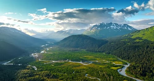 Breath-taking valley crossed by the wavy river. Spectacular mountains surround