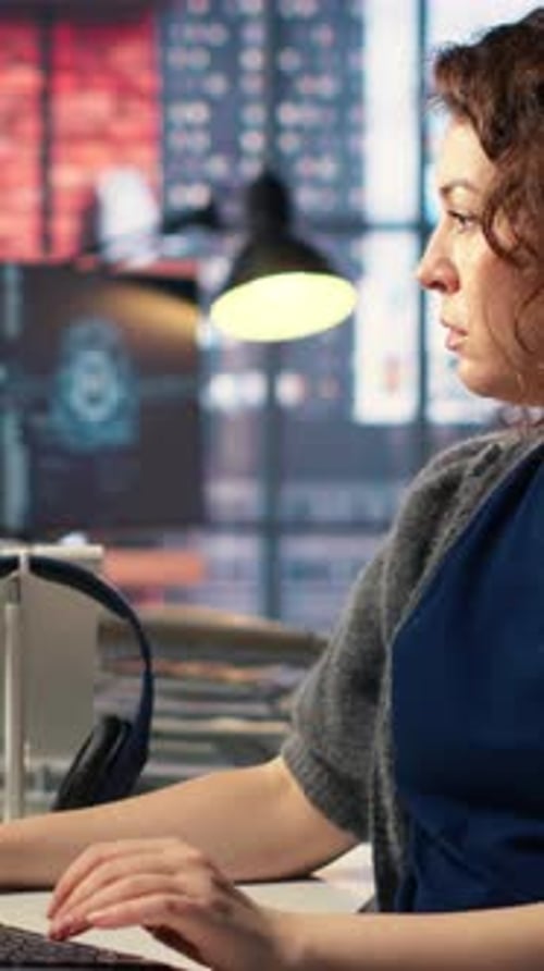 Woman Typing at Computer in Night Office