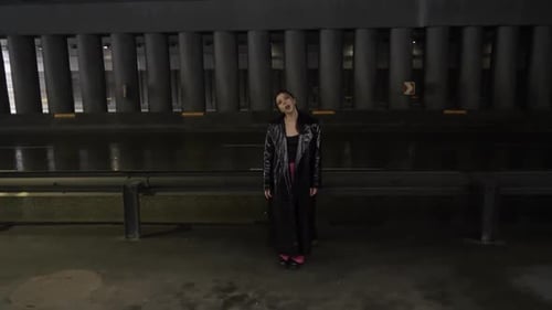 Woman Lip Syncs in Dark Urban Tunnel at Night