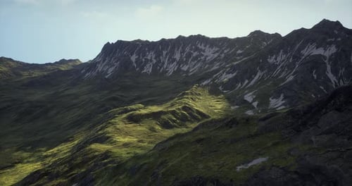 Majestic Mountain Landscape with Lush Greenery and Snowy Peaks During Daylight