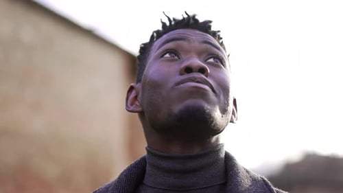 Young Man Looks Upward in Contemplation