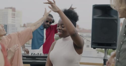 Friends Dancing Together on Urban Rooftop Party