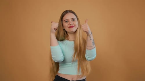 Smiling Woman Giving Two Thumbs Up