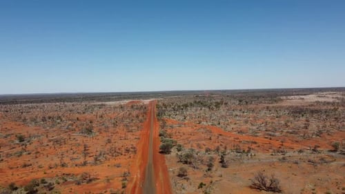 Drone Descending over country sealed and unsealed roads in the Australian Outback