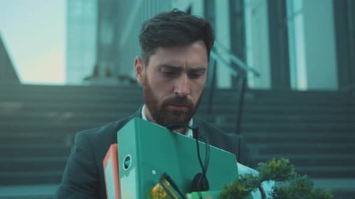 An Office Worker Experiences Grief and Anxiety While Contemplating Upcoming Layoffs and Personal