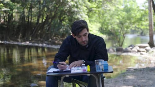 The environmentalist is testing a water Stream in the forest.