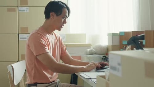 Young Adult Fulfilling Orders at a Desk