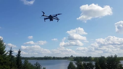 Drone Hovering Over Lake on a Summer Day