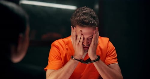 Man in Handcuffs in Interrogation Room