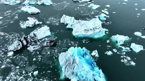 Icebergs Huge Chunks of Blue Glacier Ice Floating Arctic Nature in Iceland Ocean Aerial View