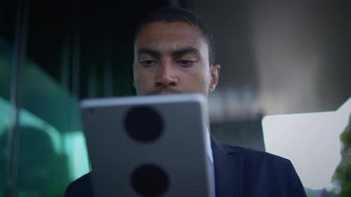 A Businessman is Actively Engaged with Innovative Technology in an Outdoor Setting