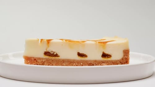 Cheesecake Slice with Caramel Drizzle on White Plate