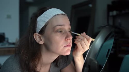 Woman Applying Eyeshadow With Brush at Home