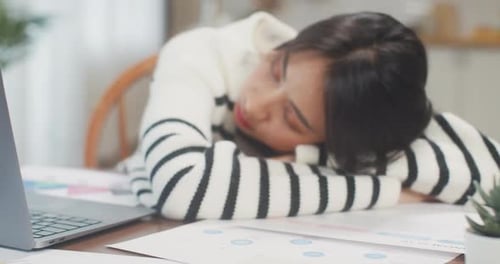 Tired Woman Sleeping at her Desk During the Day
