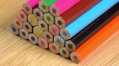Colorful pencils rotate as a background. Rainbow pencils for drawing. Assortment of colored pencil