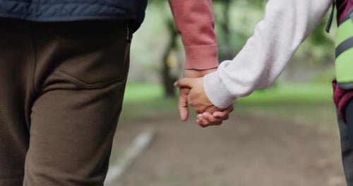 Couple Holding Hands on Nature Walk in Park