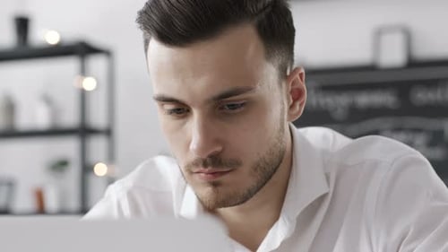 Focused Young Man Working on a Laptop