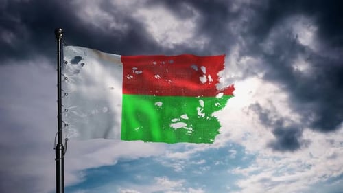Madagascar National Flag In Motion Under Thundercloud Filled Sky