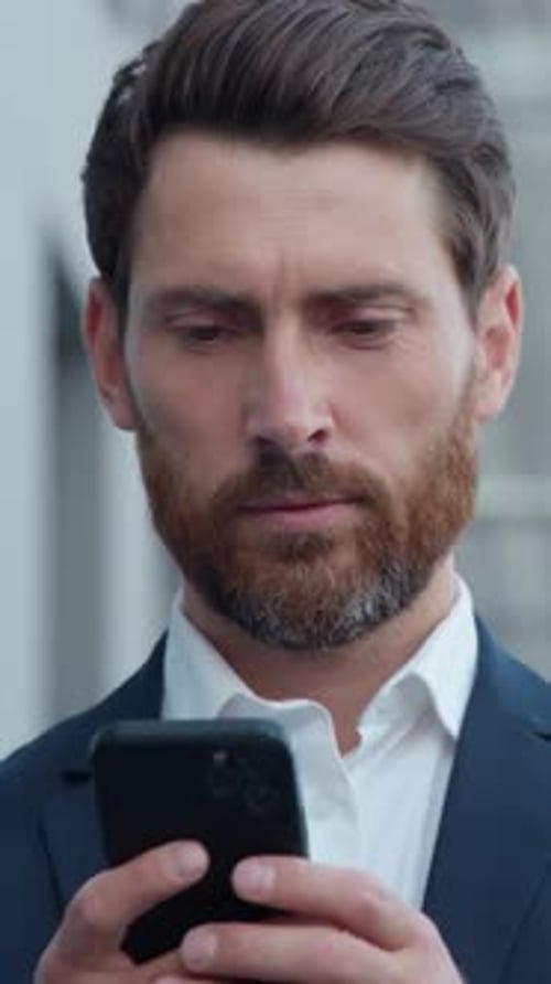 Adult Caucasian Businessman Holding Smartphone Mobile Phone in City Business Man Using Modern
