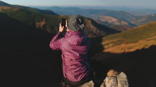 Tourist Girl Making Mountain Photo at Peak