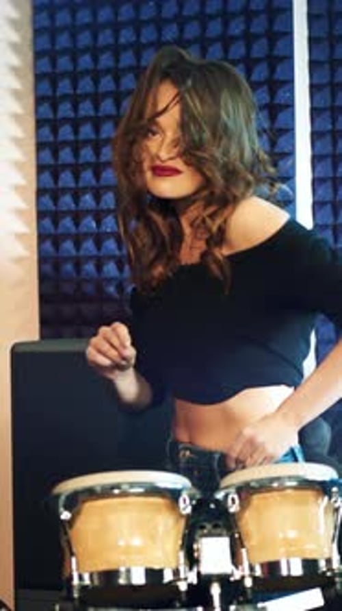 Young Woman Energetically Playing Bongo Drums