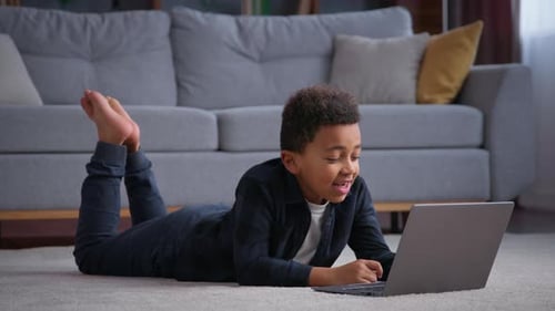 African American Kid Boy Typing Laptop at Home Happy Talking Smiling School Pupil Studying Online