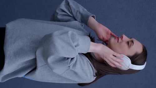 Young Woman Listening to Music with Headphones