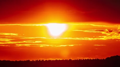 Dramatic Sunset with Sun Rays in the Sky Through Orange Layered Clouds Timelapse