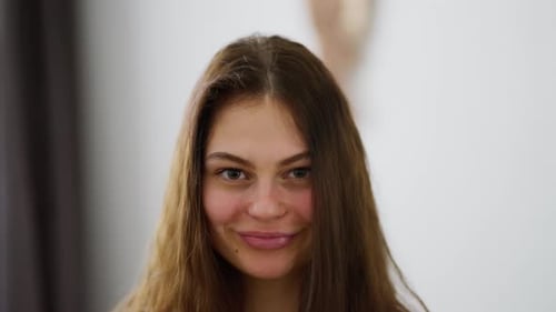 Playful Young Woman Posing and Smiling Indoors