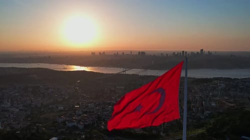 Aerial View of Cityscape with Flag at Sunset