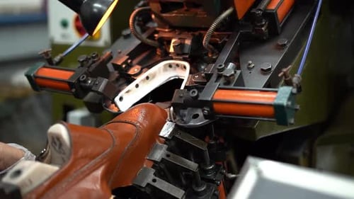 a craftsman handmade a shoe by a close up shot, insert shot