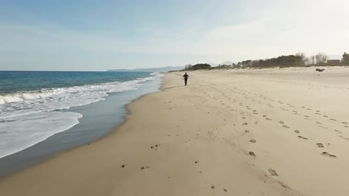Man Running On The Beach Near Ocean