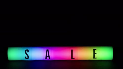 Vibrant Rainbow Sale Sign Glowing on Black Background