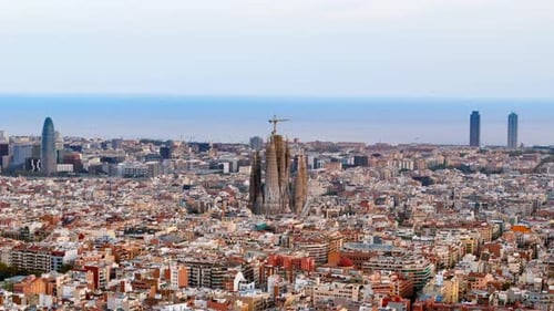 Aerial drone view of Sagrada Familia in city downtown. Famous residential district around, sea coast