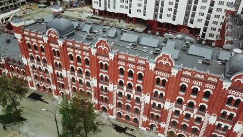 Aerial view of a red brick big multi storey building in the city street