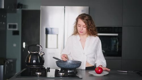 Woman Cooking in Modern Kitchen