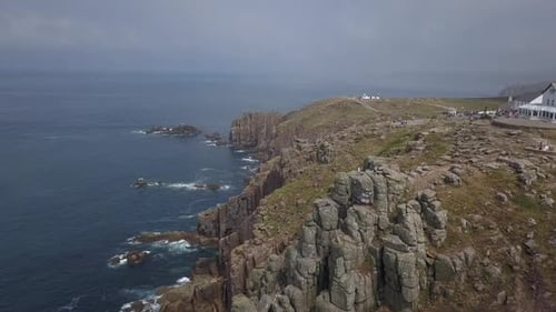 Aerial View of Rocky Coastline with Ocean Waves